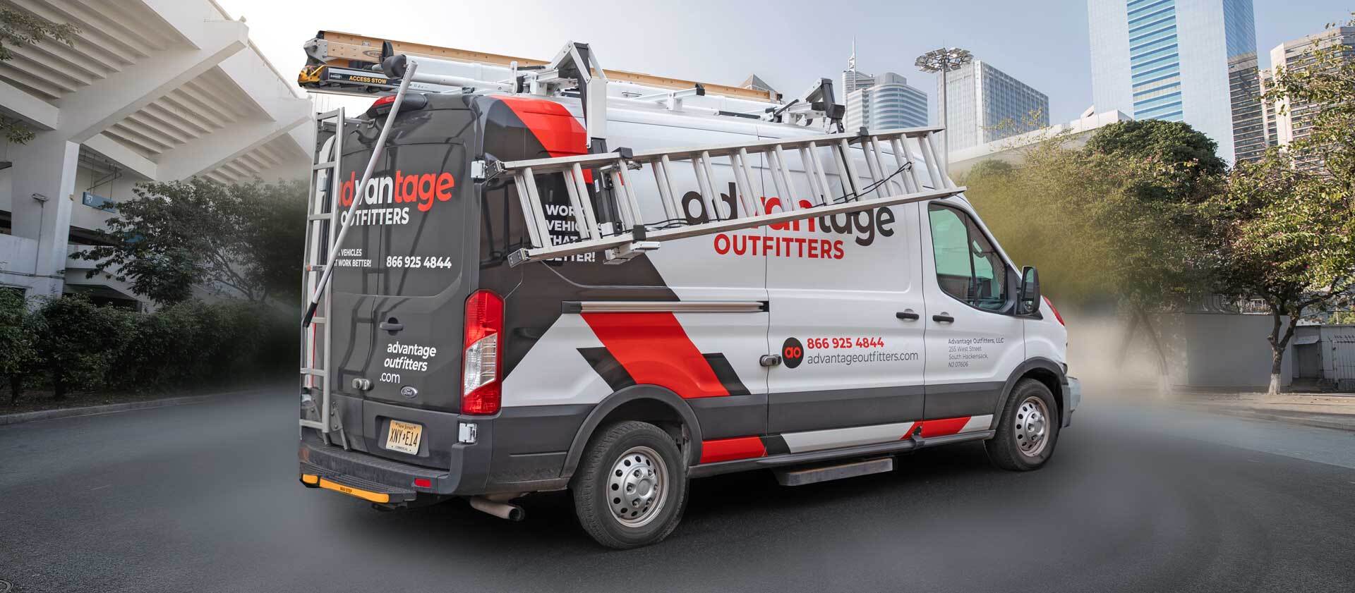 Advantage Outfitters commercial van equipped with ladder racks and shelving, parked in an urban setting